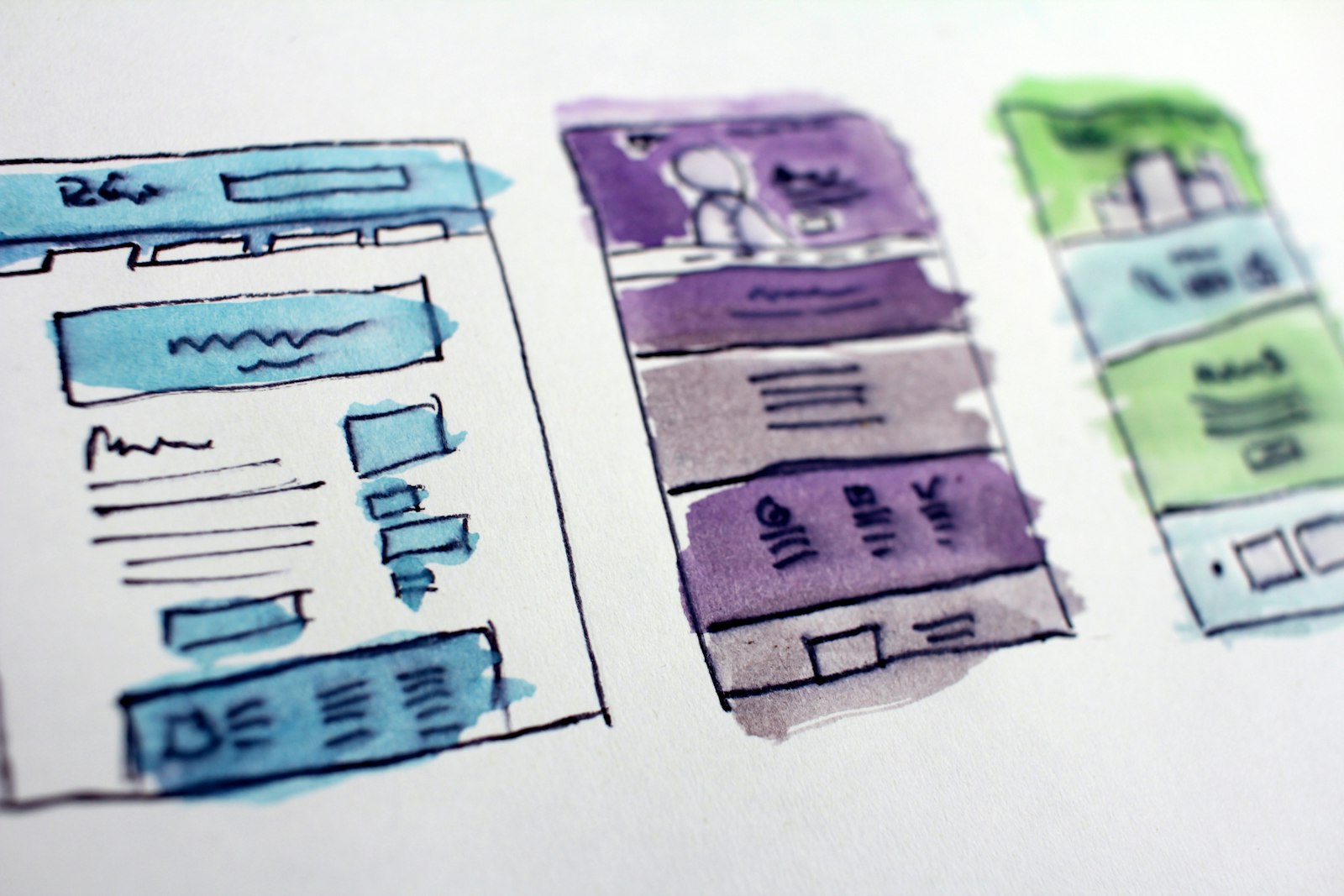 Watercolor wireframe sketches of website layouts